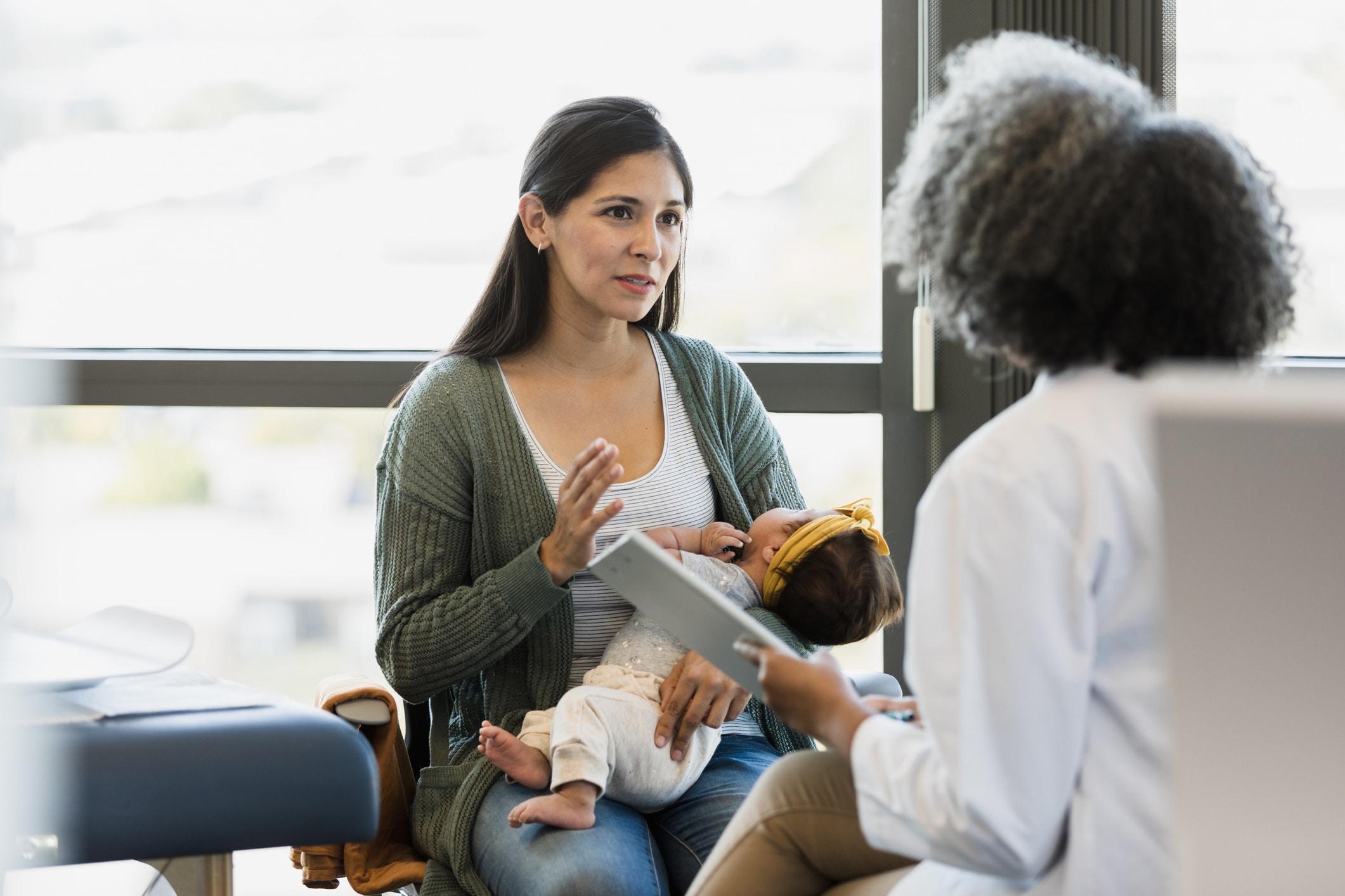 Mother and Doctor Discussing Baby's Health in Clinic