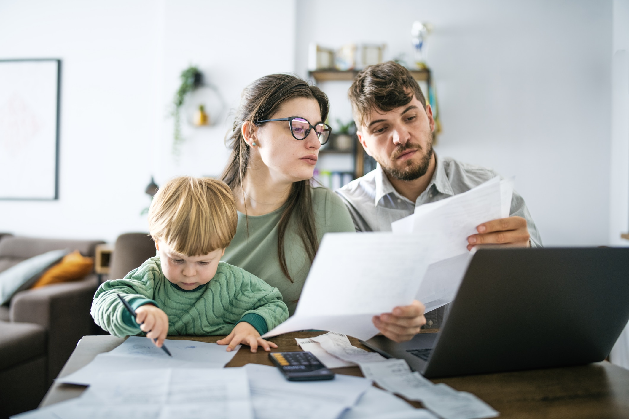 Young family man managing budget and paying bills and taxes.
