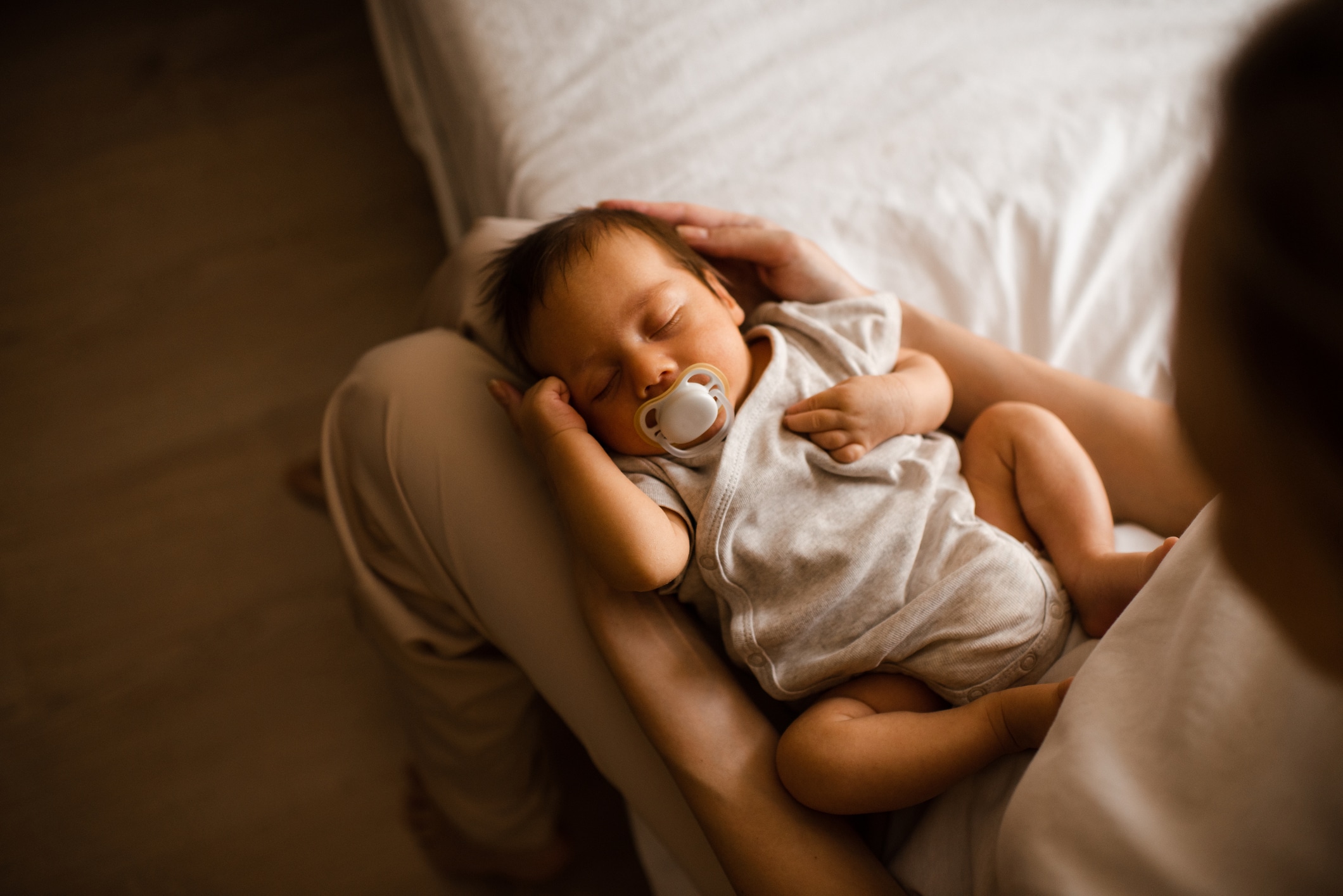 Baby lying on mother hands